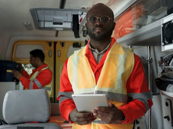 front-view-paramedic-holding-tablet_23-2149478451